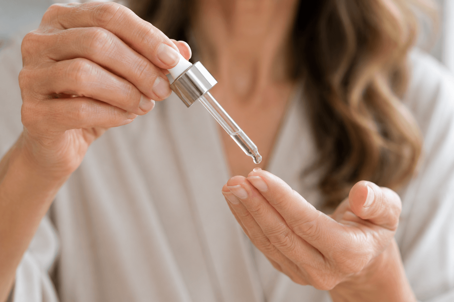 Layering skincare serum, applying products in the right order