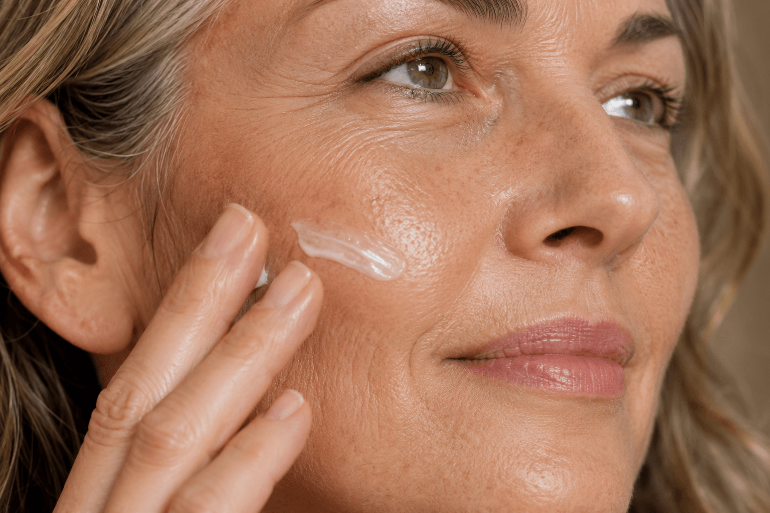 Close-up of healthy mature skin during menopause with moisturizer